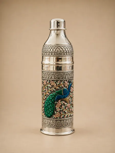 Sterling silver water bottle with a peacock in a soft pastel floral garden, handcrafted in Jaipur.