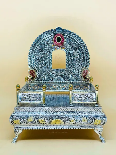 Sterling silver singhasana with a moon-arched back of deep silver nakshi engraving, handcrafted in Jaipur.