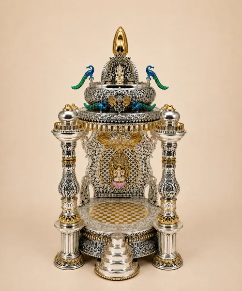 Handcrafted sterling silver home temple with Ganesh, peacocks, and gold detailing, made in Jaipur by My Dibs.