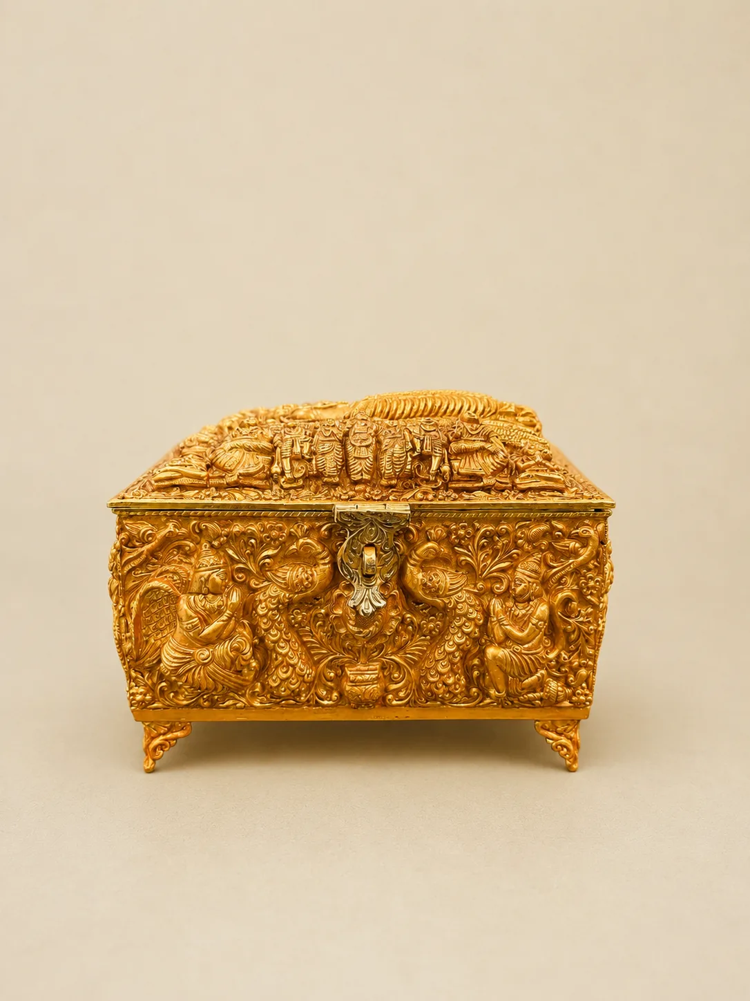 Sterling silver sacred casket in gold repoussé with deity figures, handcrafted in Jaipur.