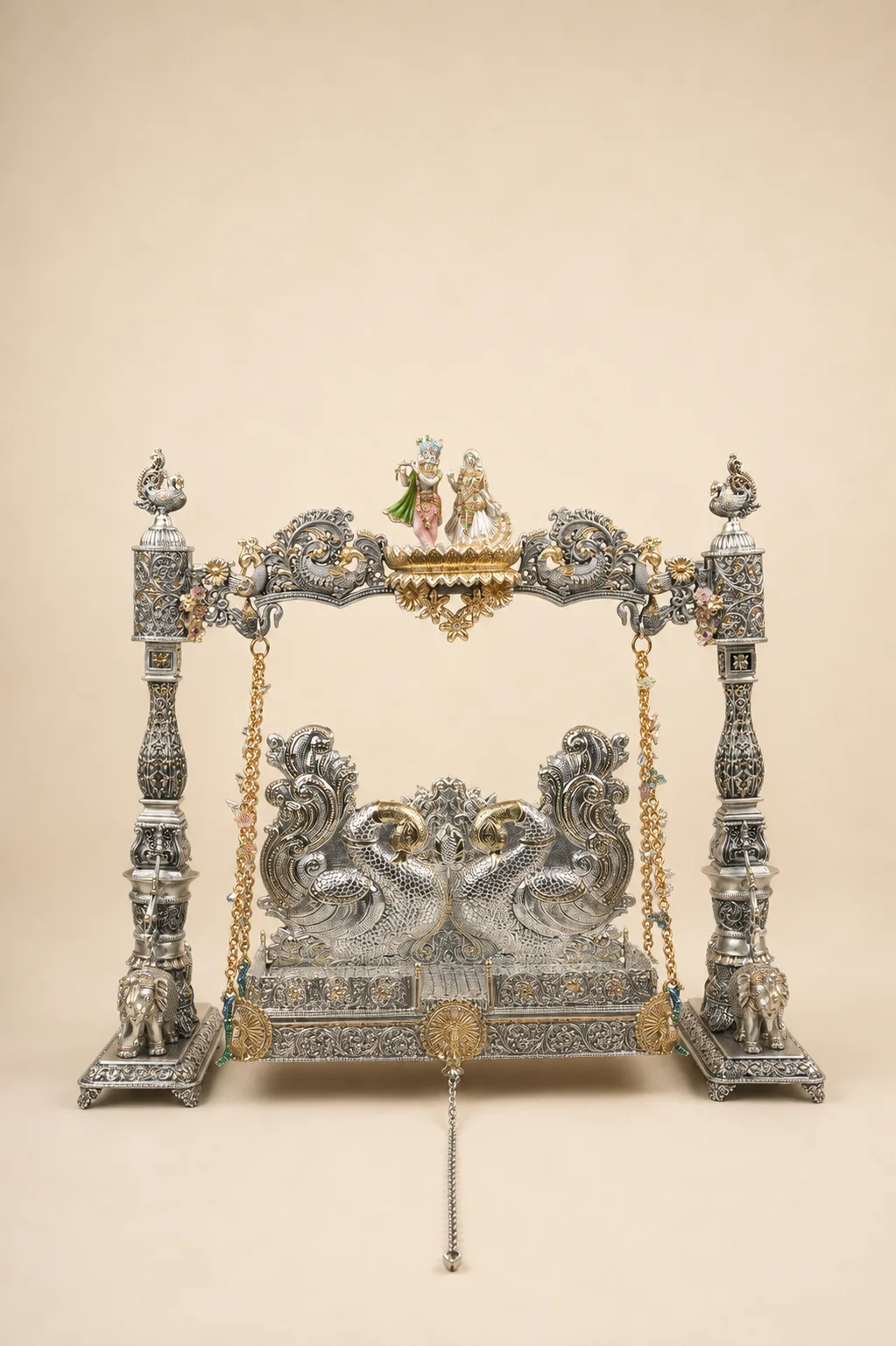Sterling silver deity swing with a peacock throne and Radha-Krishna figures, handcrafted in Jaipur.