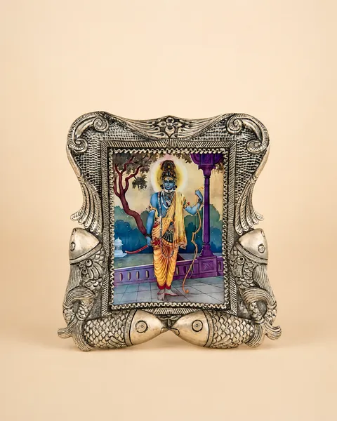 Sterling silver photo frame carried by fish in raised relief, handcrafted in Jaipur.