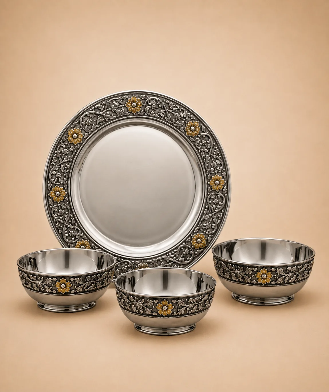 Sterling silver dinner set with a running gold-flower vine border, handcrafted in Jaipur.