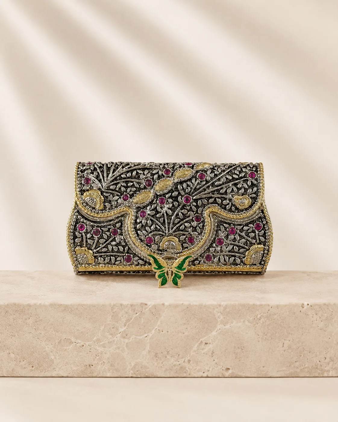 Relief-carved sterling silver clutch with an enamel butterfly, handcrafted in Jaipur.