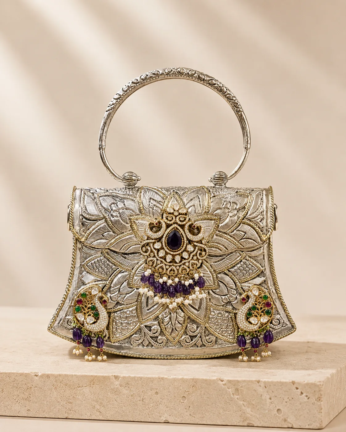 Relief-carved sterling silver handle bag with a lotus motif, handcrafted in Jaipur.
