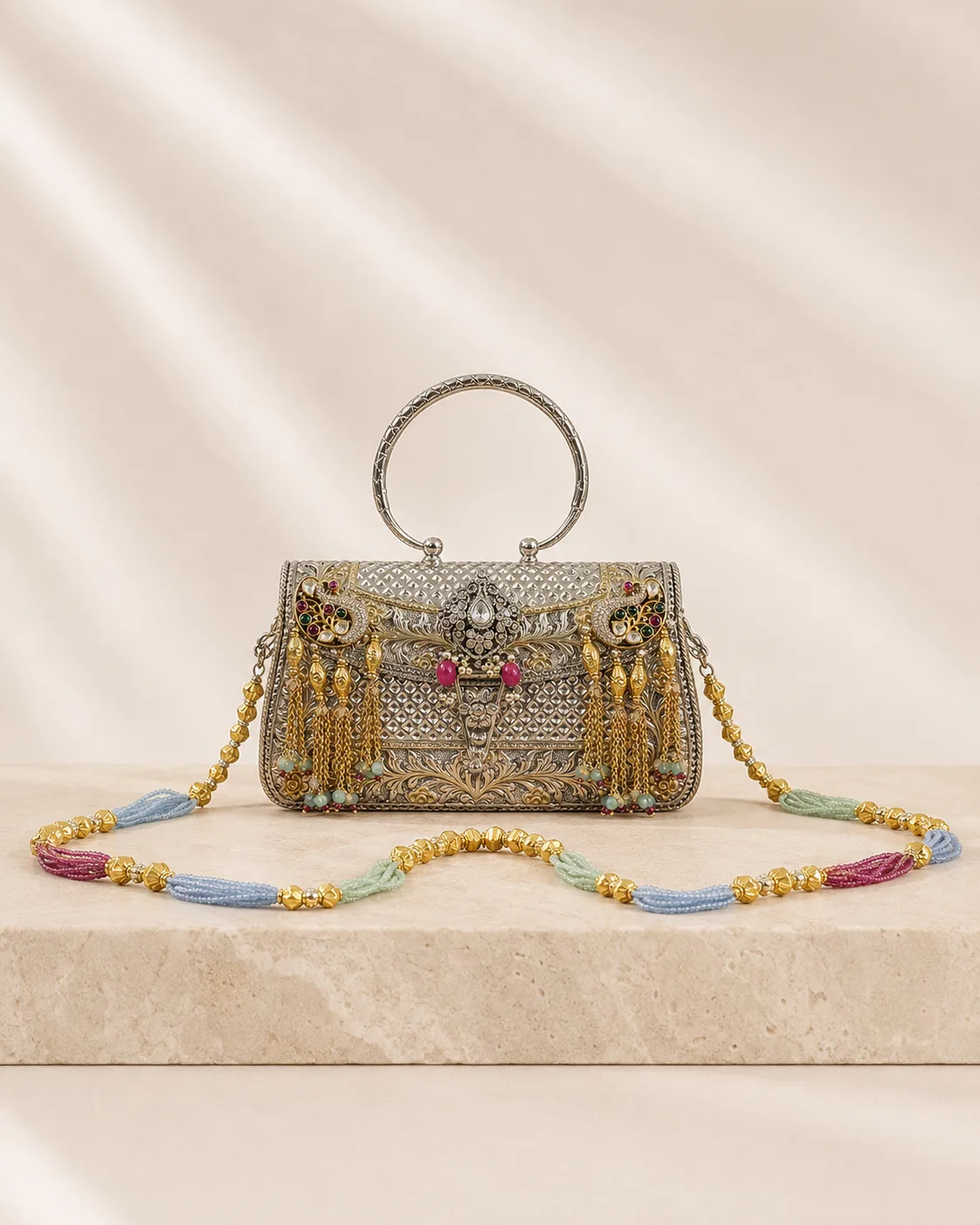 Sterling silver handle bag with peacock detail and a beaded chain, handcrafted in Jaipur.