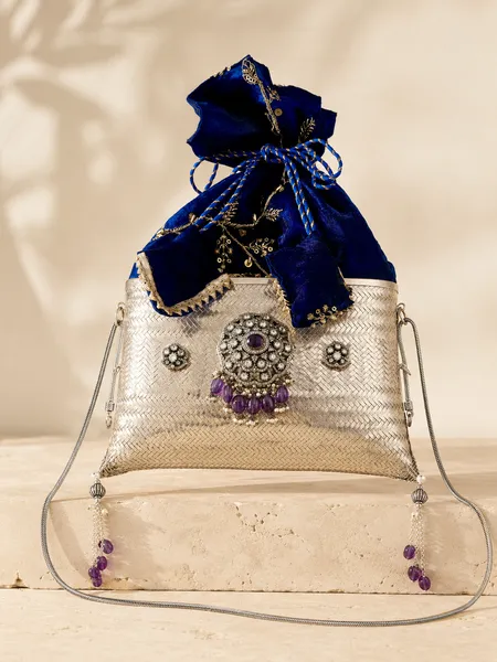 Sterling silver evening purse with sapphire-blue velvet, handcrafted in Jaipur.
