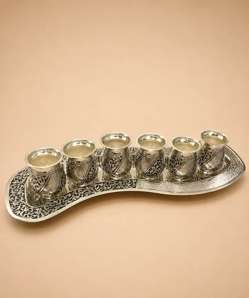 Intricate hand-engraved silver tea pot and tray set